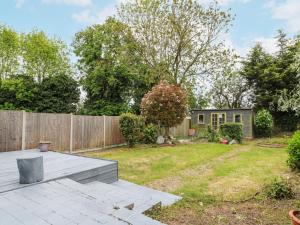 a backyard with a wooden fence and a house at 46 Dalby Road in Leicester