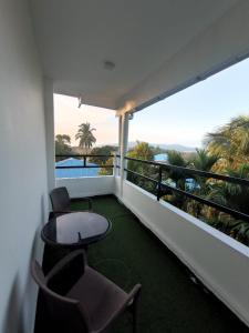 a room with a balcony with a table and chairs at Hotel Blu Horizon in Port Blair