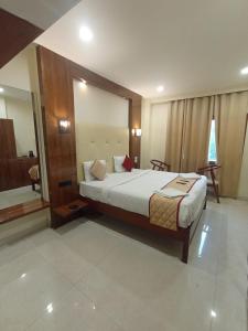 a bedroom with a bed and a large mirror at Hotel Blu Horizon in Port Blair