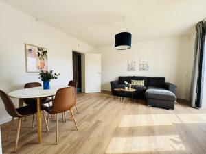 a living room with a couch and a table at aday - Lodsejervej Suite 4 in Randers