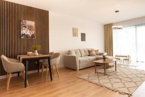 a living room with a couch and a table at ONL Apartments in Dunajská Streda