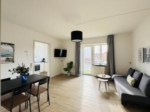 a living room with a couch and a table at aday - Lodsejervej Suite 3 in Randers