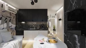 a kitchen with a couch and a table in a room at Black Velvet & Dark Elegance in Opole