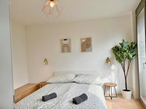 a bedroom with a bed with two slippers on it at Modern Stylish Luxury Apartment with Parking in Vienna