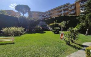 a park with a bench in front of a building at Portofino - Near the Sea, Pool -Tennis - Wifi in Rapallo