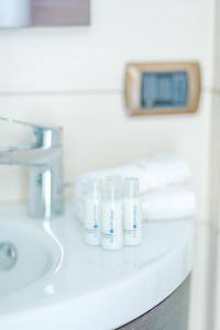 a row of white bottles sitting on a bathroom counter at Portofino - Near the Sea, Pool -Tennis - Wifi in Rapallo