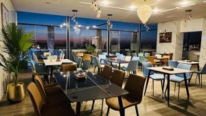 a restaurant with tables and chairs with a view at Tetra Tree Hotel 1 in Wadi Musa