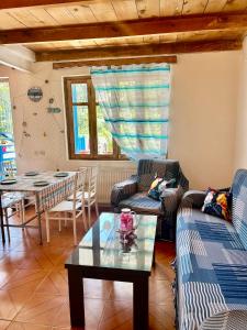 a living room with two couches and a table at SOPHIE GuestHouse in Grigoleti