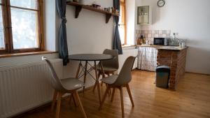 a kitchen with a table and chairs and a counter at Mokka Vendégház in Kismaros