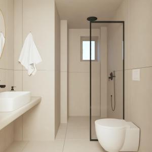 a bathroom with a shower and a toilet and a sink at Haus Platanos Apartments & Bungalows by the Sea in Vourvourou