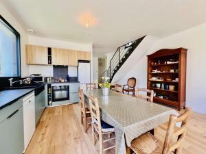 a kitchen and dining room with a table and chairs at Villa 7 pièces à Quiberon - Proche plage, jardin, parking, WiFi - FR-1-478-307 in Quiberon