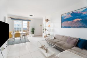 a living room with a couch and a table at La Arena By Médano Rentals in El Médano
