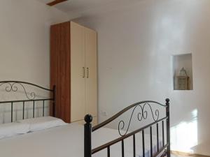 a bedroom with a bed and a cabinet at Arbinovo Lodge in Ohrid
