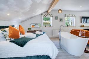 a bedroom with a large bed and a bathtub at The P19 Sty - 1 Bedroom Studio - Princes Gate in Ludchurch