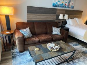 a living room with a couch and a bed at Laidback n Lazy at Landmark Resort in Myrtle Beach +17 photos