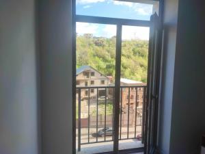 an open window with a view of a building at COMFY DILIJAN Apartment in Dilijan