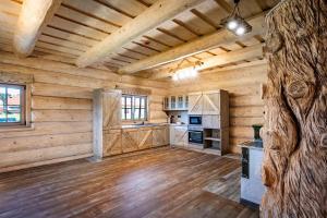 a large room with wooden walls and wooden floors at Zrub Sova - Važec - 3 bedroom - 2 bathroom in Važec +22 photos