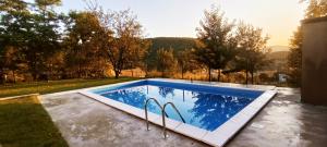 a swimming pool in the backyard of a house at Villa Nature Sarajevo in Sarajevo