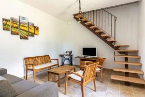 a living room with a couch and a staircase at GuestHost - Ca'Solare - Country Villa X4 in San Cristoforo de Valli
