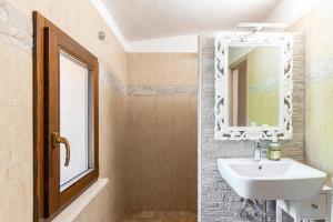 a bathroom with a sink and a mirror at GuestHost - Ca'Solare - Country Villa X4 in San Cristoforo de Valli +16 photos
