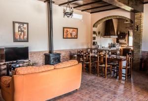 a living room with a couch and a stove at Casa Rural Villa Lucrecia in La Lantejuela