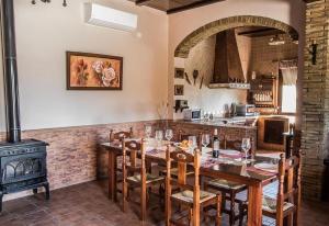a dining room with a table and a stove at Casa Rural Villa Lucrecia in La Lantejuela