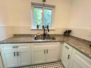 a kitchen with a sink and a window at 3 Bedroom Apartment with Backyard Oasis (1T) in Miami +56 photos