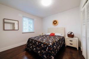 a bedroom with a bed and a dresser and a window at 3 Bedroom Apartment with Backyard Oasis (1T) in Miami