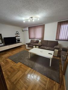 a living room with a couch and a coffee table at Villa Nature Sarajevo in Sarajevo