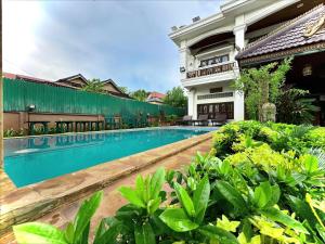 a swimming pool in front of a house at Shining Angkor Boutique Hotel in Siem Reap +40 photos