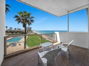 a balcony with chairs and a view of the beach at The Sharon Seaside Retreat in Herzliya B