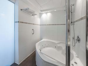 a white bathroom with a tub and a shower at The Sharon Seaside Retreat in Herzliya B