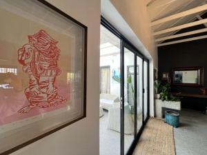 a living room with a painting on the wall at Helder Haven Cottage in Somerset West