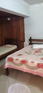 a bedroom with two beds with a pink blanket at Casa do guerreiro in São João del Rei +20 photos