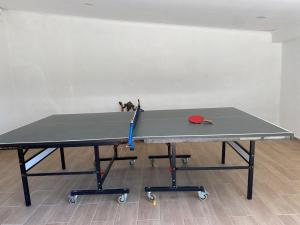 a ping pong table in a room with a ping pong racket at Guincho Rural Villa in Cascais