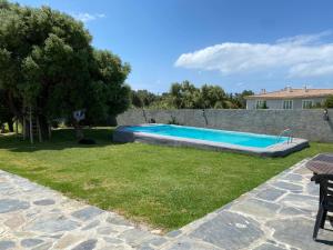 a swimming pool in the yard of a house at Guincho Rural Villa in Cascais