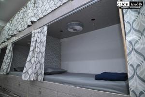 a bunk bed in a loft bed with curtains at Skyline backpackers in Hyderabad