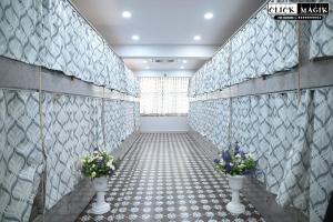 a hallway with two vases with flowers in it at Skyline backpackers in Hyderabad