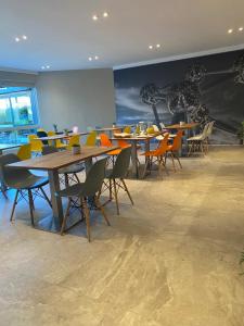 a dining room with tables and chairs and a mural at Sleep & Go Brussels Expo Hotel in Brussels