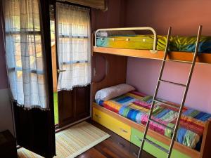 a room with two bunk beds and a door at La terraza de Los Picos de Europa in Potes