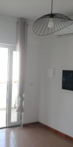 a room with a large window and a fan at Casa dei gerani in Montegiordano