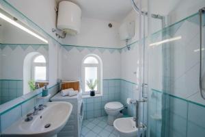 a blue bathroom with a sink and a toilet at CASA VACANZE MARIANTONIETTA-Amalfi Coast in Praiano
