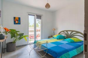 a bedroom with a bed with a colorful blanket at Coeur de Lavande in Vinon-sur-Verdon +17 photos