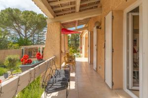 a porch of a house with chairs and flowers at Coeur de Lavande in Vinon-sur-Verdon