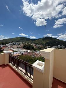 a balcony with a view of a city and mountains at Departamento San Bernardo - Céntrico Salta in Salta