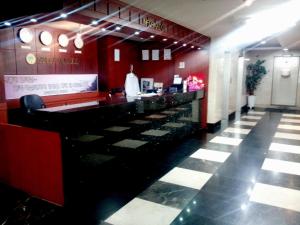 a bar in a restaurant with a red wall at Bali Tourist Hotel in Seoul