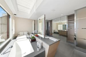 a bathroom with a large tub and a sink at Exclusive 3 Bedroom Luxury penthouse in Geneva +38 photos