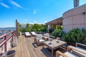 a deck with a table and chairs on a building at Exclusive 3 Bedroom Luxury penthouse in Geneva
