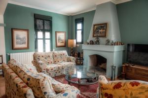 a living room with a couch and a fireplace at Finca Orate in Mairena del Alcor