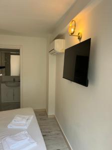 a room with a bed and a television on a wall at Maison d' Orange - Chambres in Saint-Tropez +19 photos